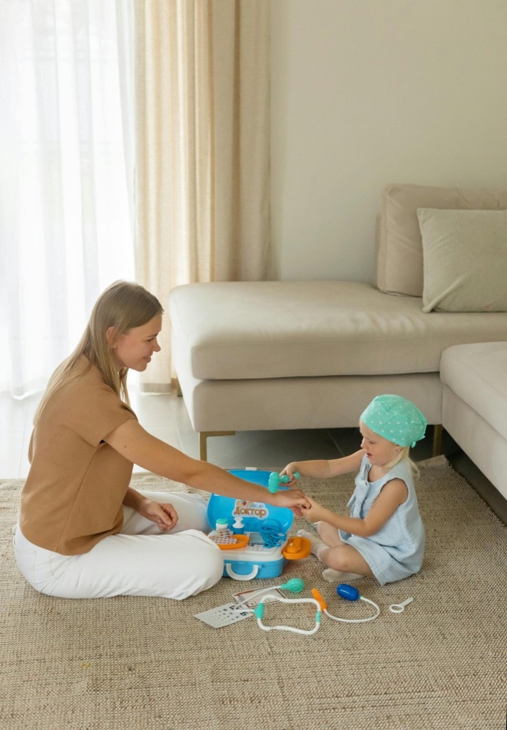 Mom playing doctor with her daughter — therapy for nurses and medical moms in Minnesota