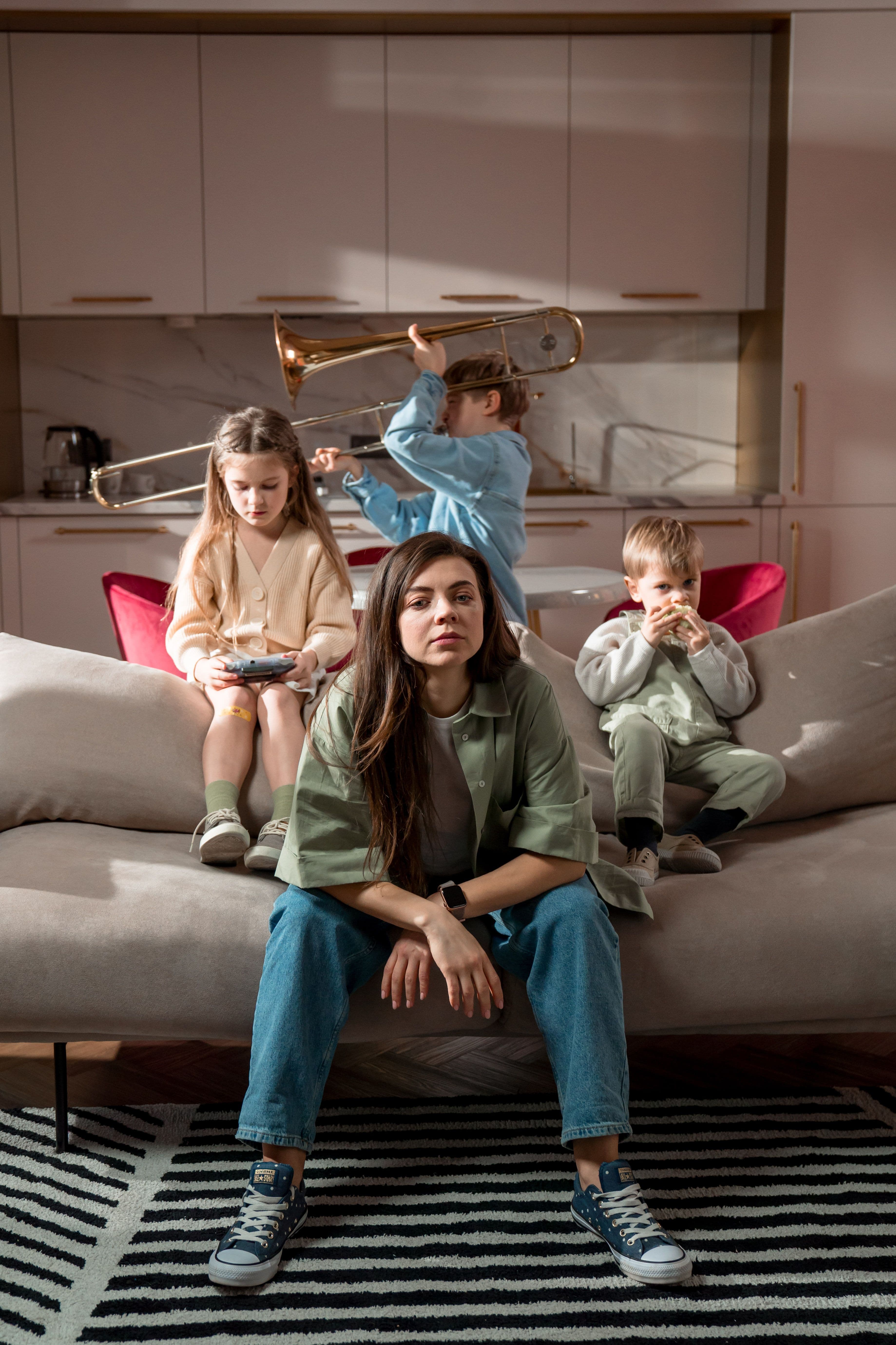 Exhausted mother while her children are distracted, maternal burnout, mom guilt, and the internal question 'am I a bad mom?'.