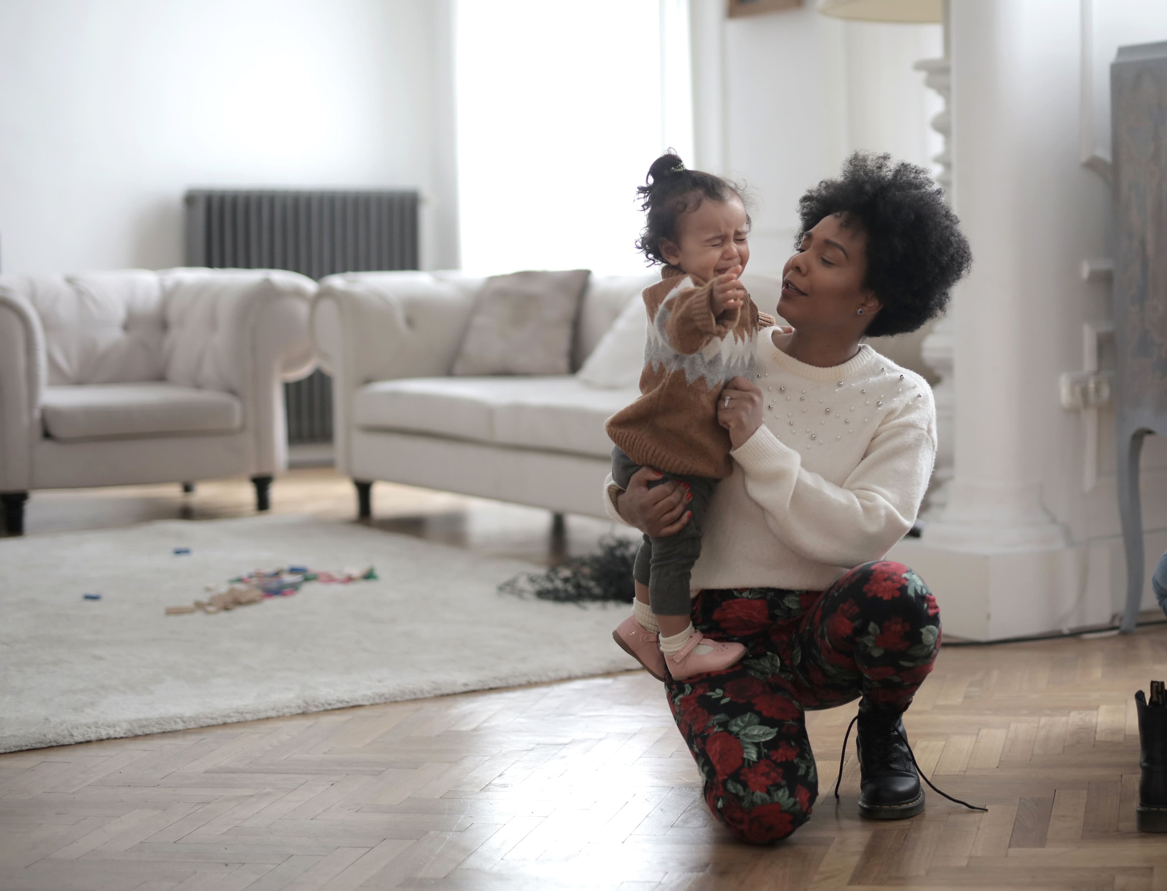 Mother comforting a crying toddler throwing a tantrum. Illustrating therapy for moms in Minnesota